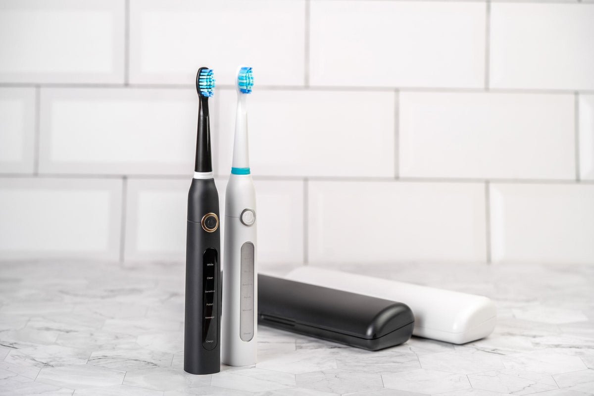 An electric toothbrush on a bathroom shelf