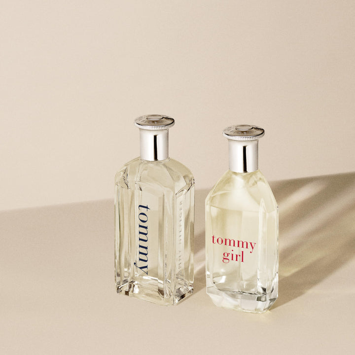 Clear curved 100 ml perfume bottle with silver cap, floral-woody scent for Women