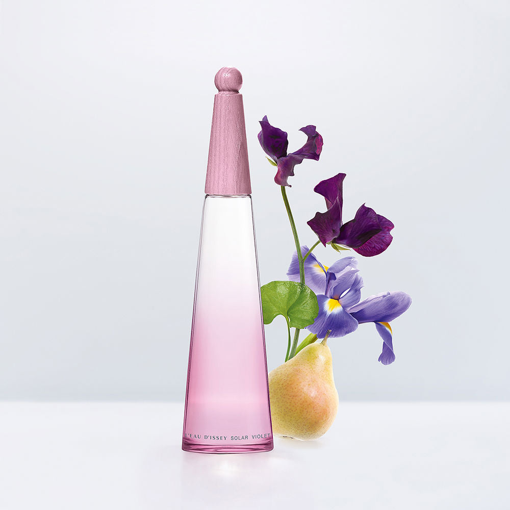 Issey Miyake Minimalist pink gradient glass perfume bottle with tapered silhouette and rounded wooden cap