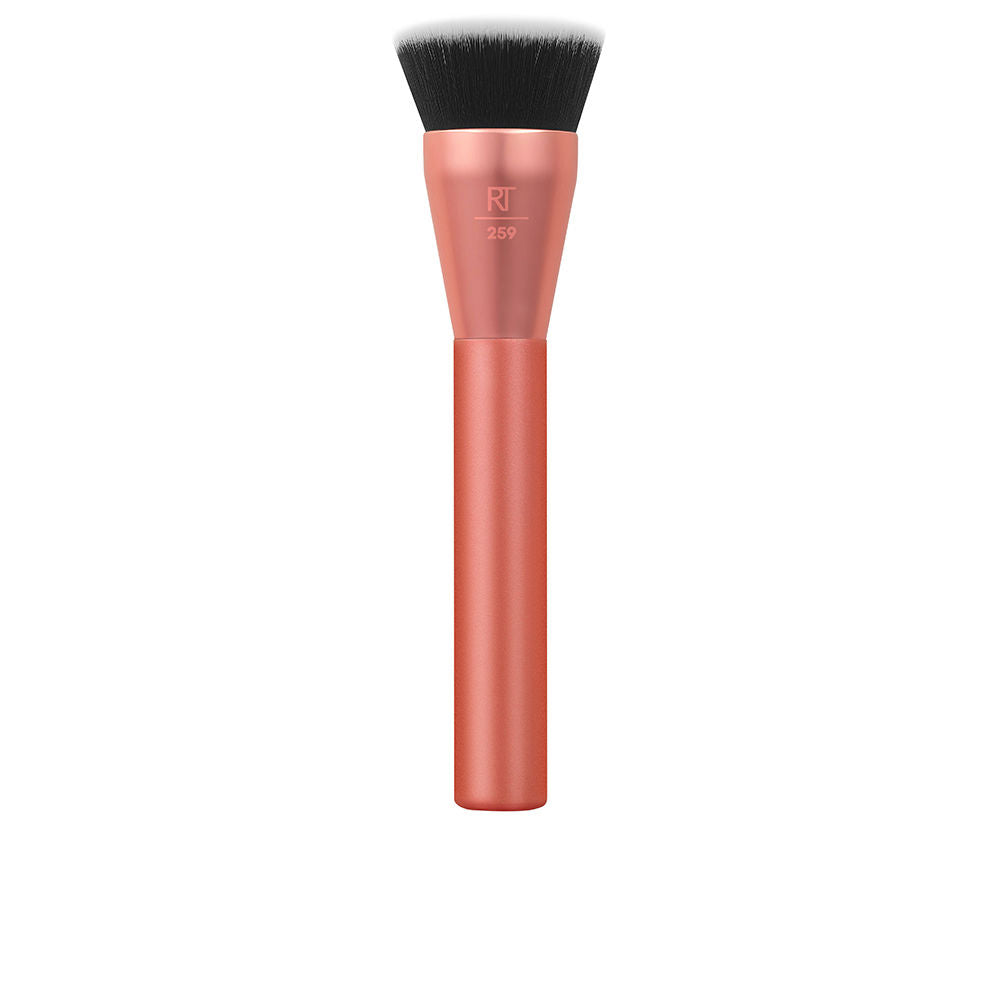 Real Techniques Rose gold metal-handle flat-top makeup brush with dense synthetic bristles, black and white accents