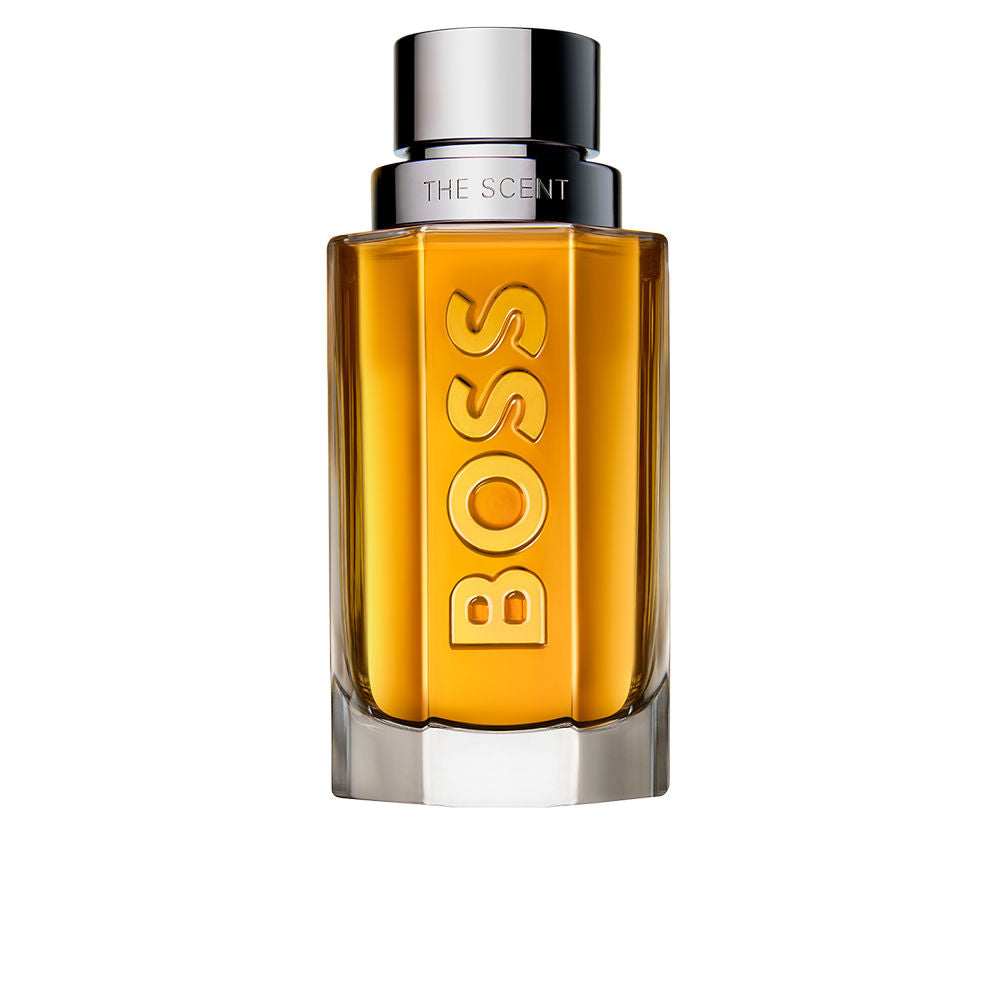 Amber liquid in transparent rectangular glass bottle with metallic cap and embossed BOSS text, Hugo Jules