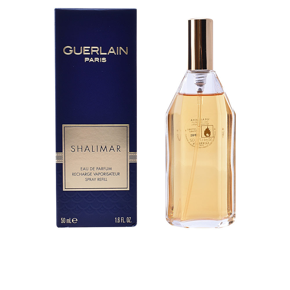 Guerlain Dark blue glass perfume spray refill with gold cap, transparent bottle showing amber liquid, boxed