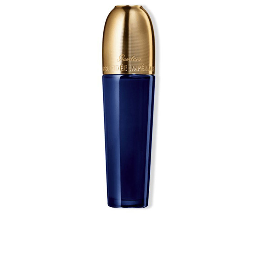 Dark blue tall cylindrical bottle with rounded gold cap, glass body and metallic cap — Guerlain.