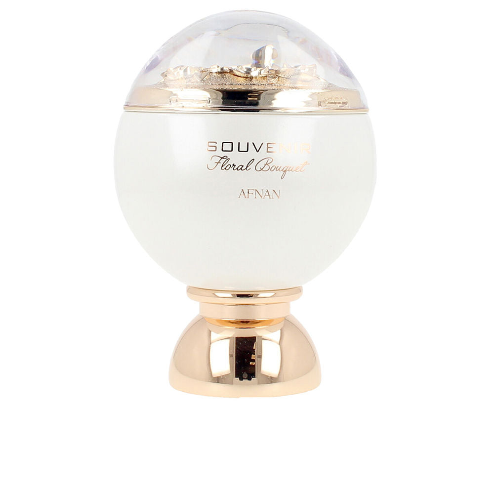 White dome perfume bottle with gold decorative base and floral detail under transparent top, Afnan.