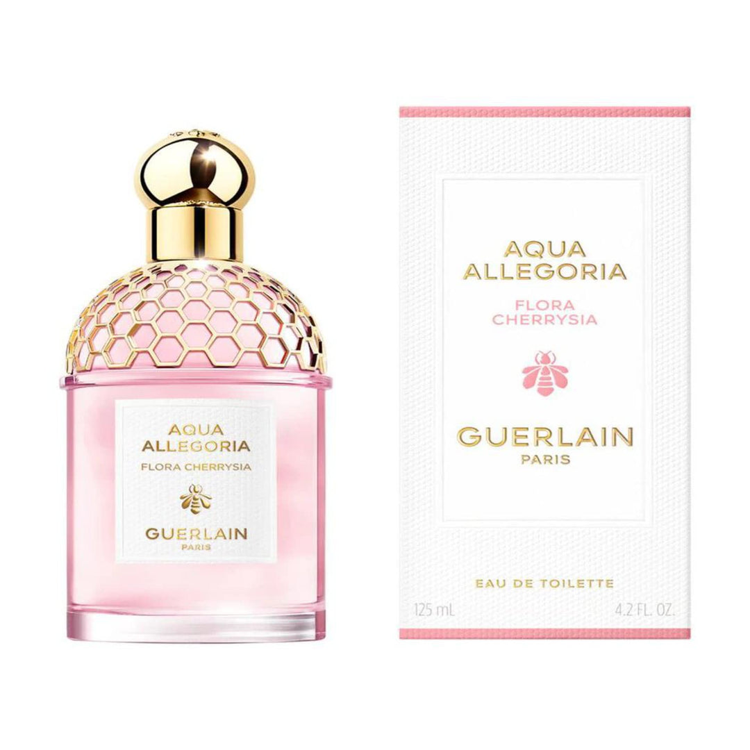 Guerlain Glass perfume bottle with rounded shoulders and gold cap, amber liquid visible
