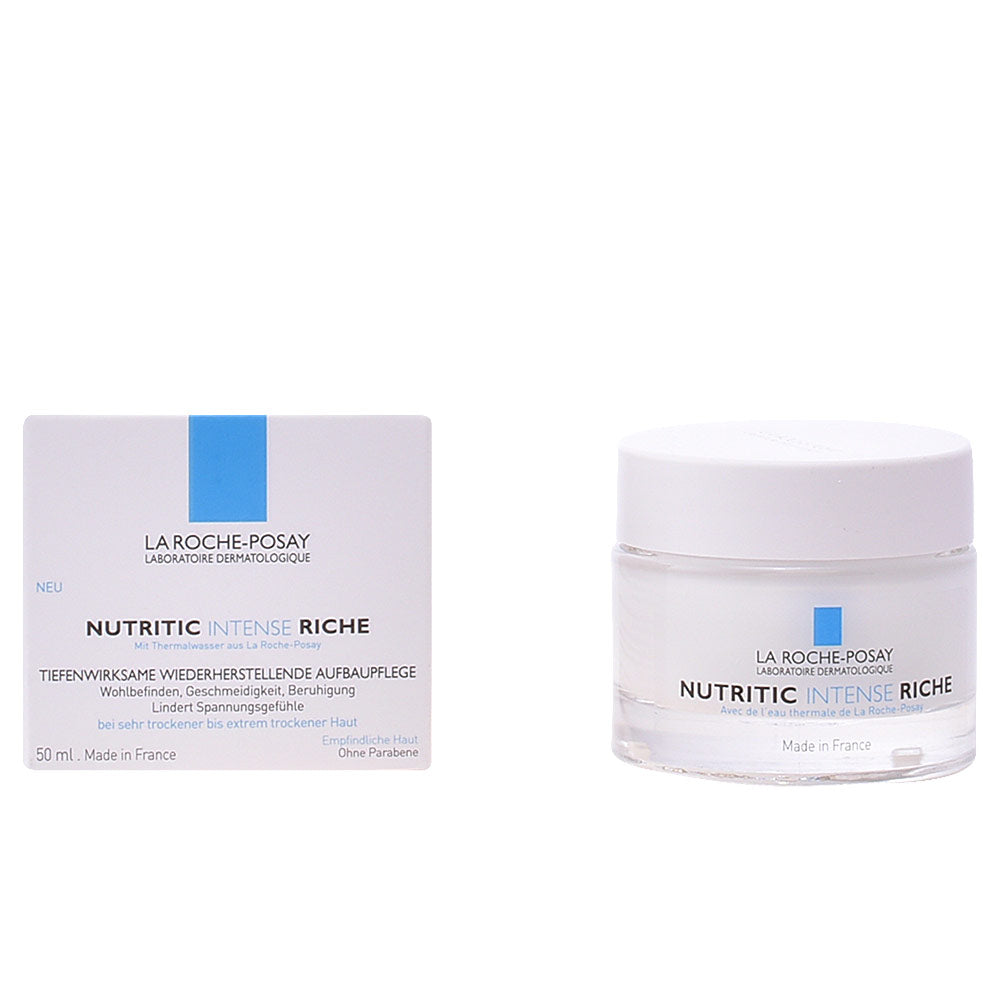 Minimalist cylindrical face cream jar with white screw-on lid, transparent lower jar and blue logo, la Roche Posay