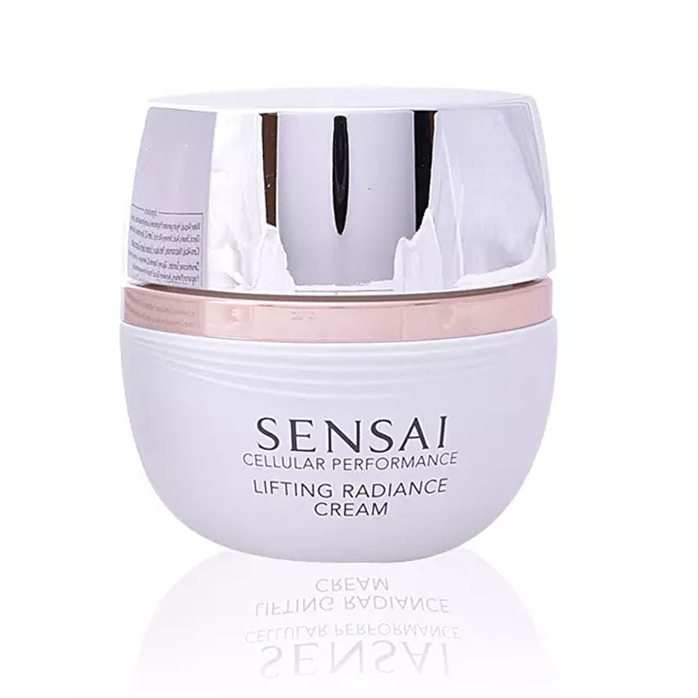 Sensai round plastic cream container in white with reflective silver and rose gold lid, sleek modern design.
