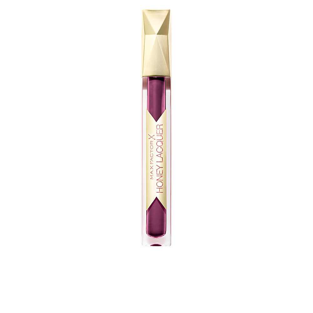 Max Factor Modern plastic lip gloss tube with transparent body, visible purple liquid, geometric gold cap, vertical label