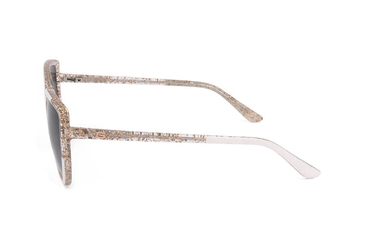 White cat-eye sunglasses with gold flecks and gradient dark lenses on neutral background