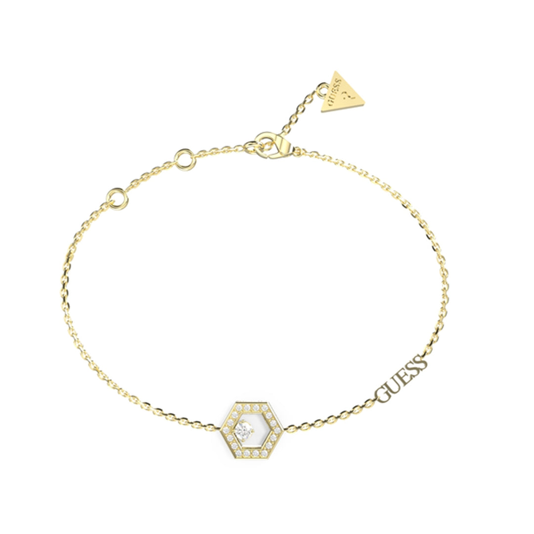 Delicate gold chain bracelet with a hexagon stone charm and small triangular charm on wrist