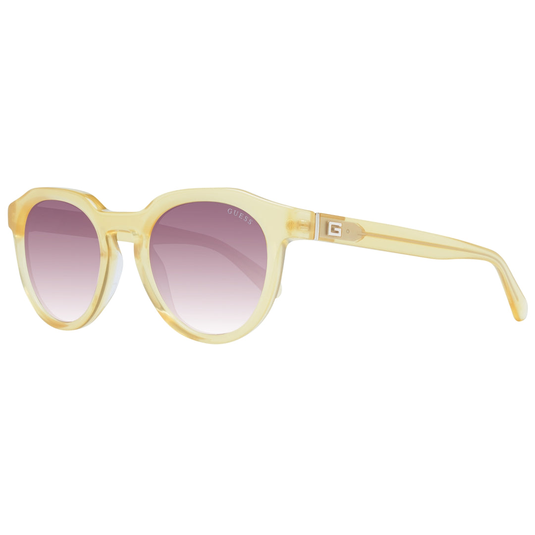 Yellow round sunglasses with purple gradient lenses and Guess logo on lens and temple