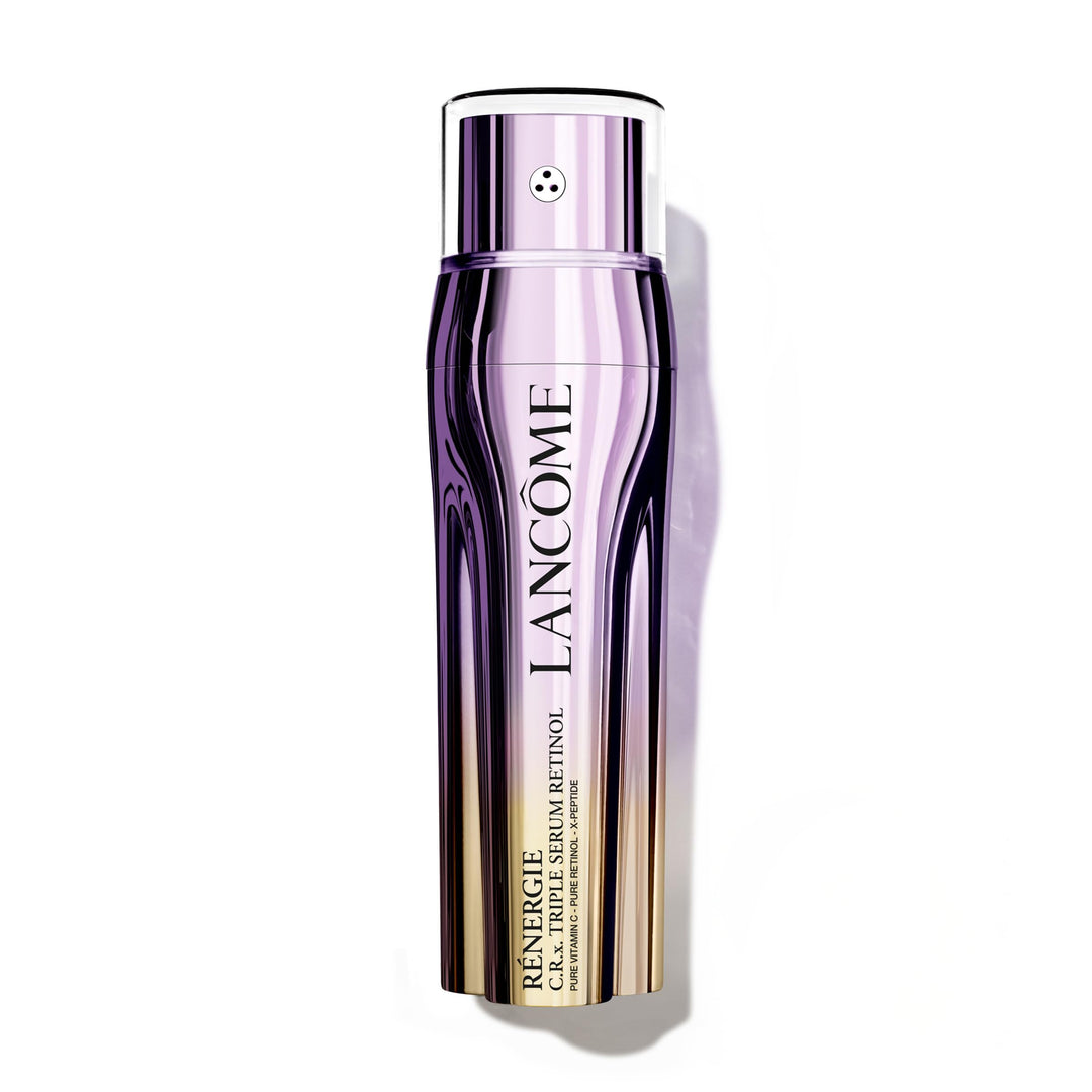 Glass triple‑chamber serum bottle showing clear and amber liquids, polished metallic cap, Lancôme label visible