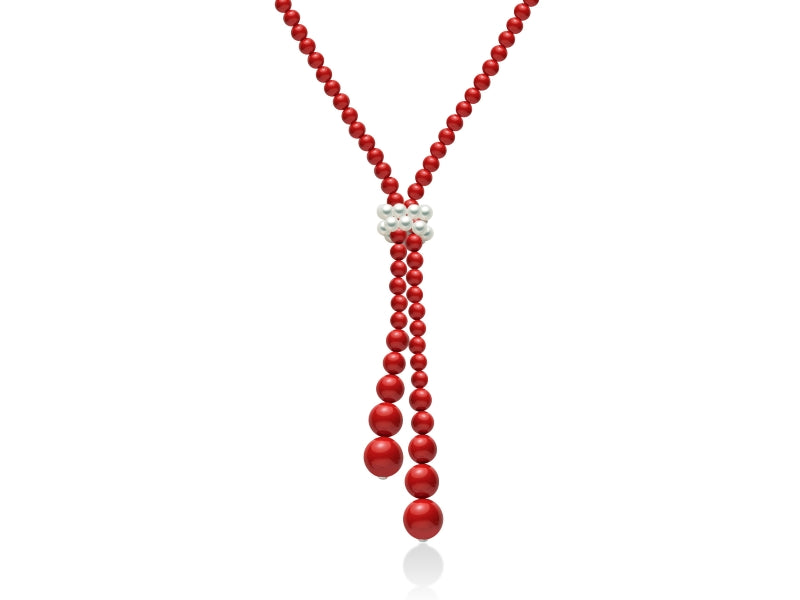 Lariat beaded necklace with red graduated beads and white pearl cluster, dangling ends on neutral background